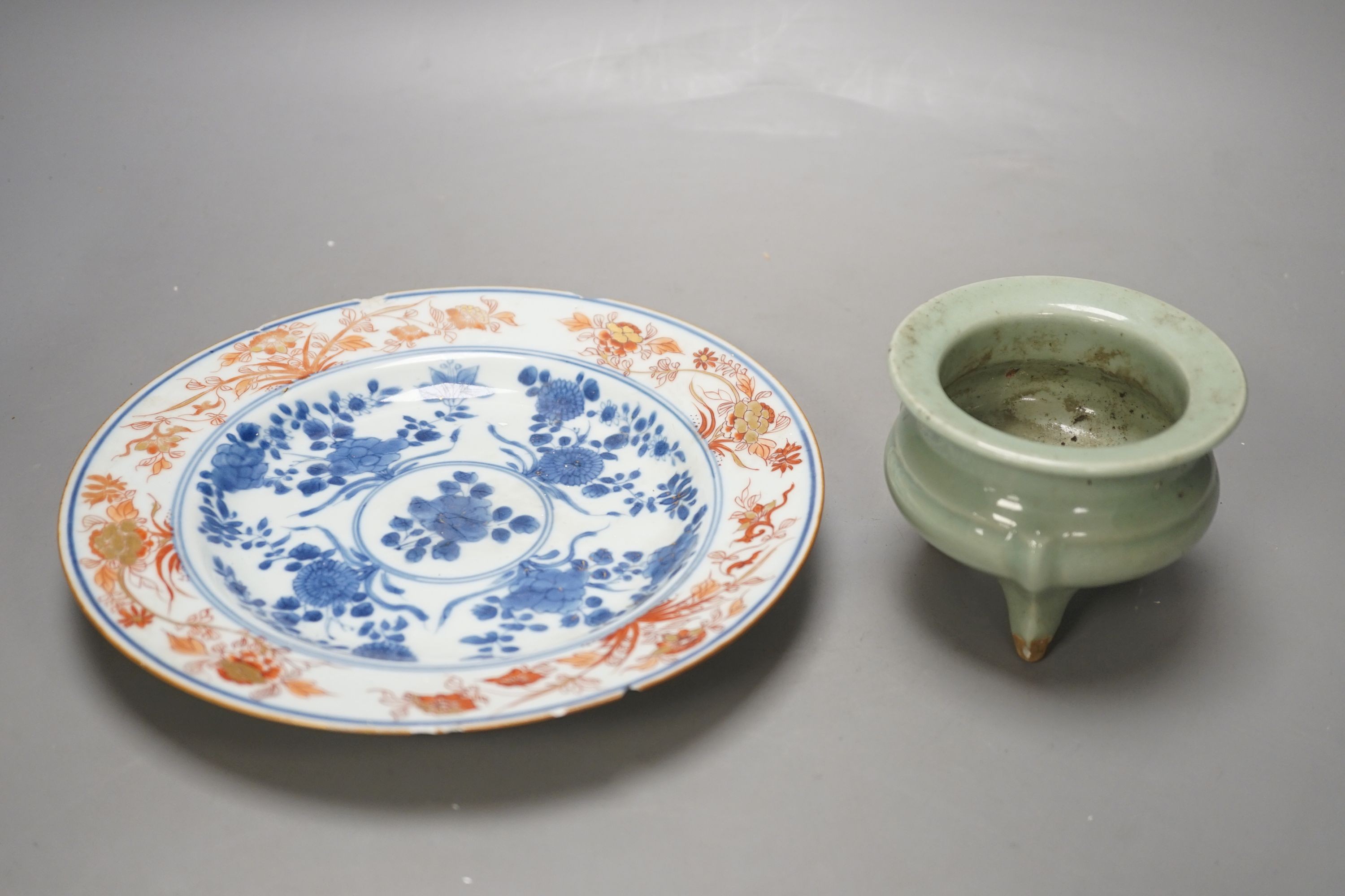 A Chinese Imari plate, Kangxi period and a Chinese celadon ground tripod censer, plate diameter 22cm